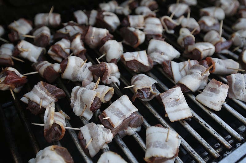 Staff file photo / Wrapping deer meat in bacon before grilling it, as pictured, is one way to enhance the flavor, but the process of getting the best-tasting venison begins even before the hunter fires a shot in the woods, writes "Guns & Cornbread" columnist Larry Case.