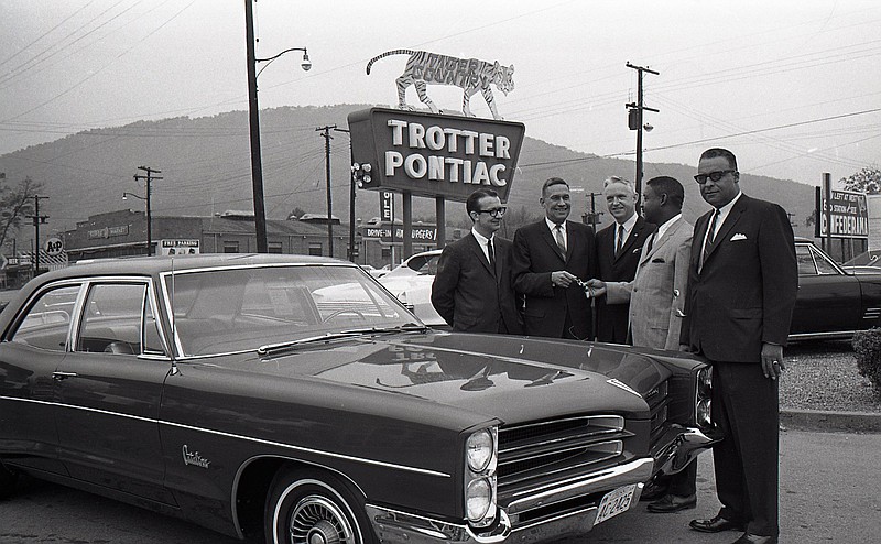 Chattanooga News-Free Press archive photo via ChattanoogaHistory.com / This 1965 photo shows the Trotter Pontiac dealership donating an automobile to Chattanooga City school system officials. The photo was shot by newspaper staff photographer Bob Sherrill.