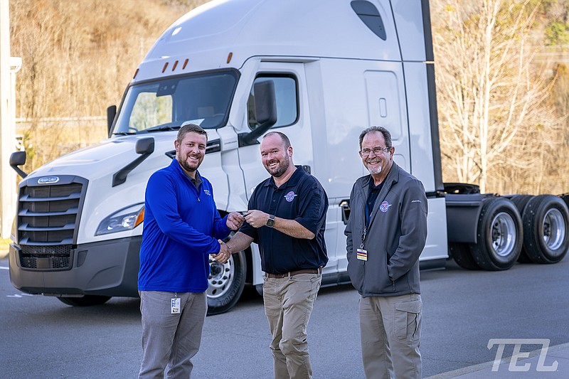 Contributed photo / Turning over the keys to a new commercial truck are, from left, David Bellner of Transport Enterprise Leasing, and Chris Hall and John Volpe of Remote Area Medical.