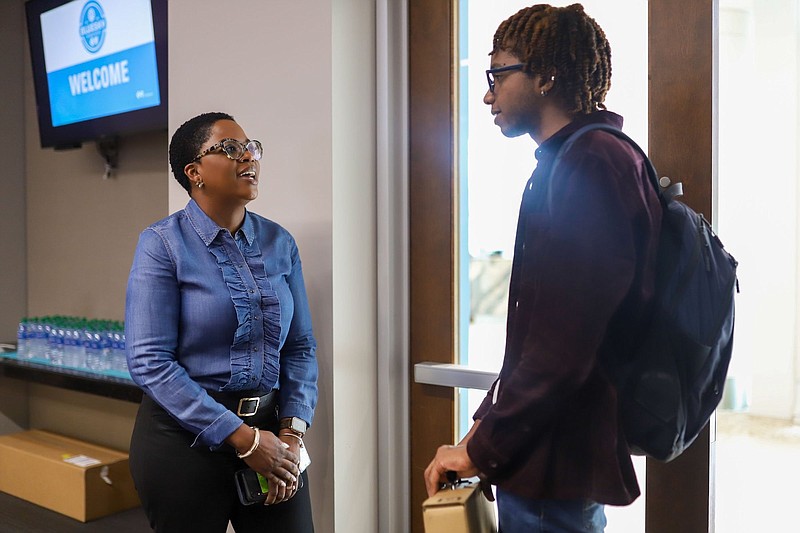 Staff photo by Olivia Ross  / Jayden Davis talks with Destiny Griffin, BlueCross BlueShild of Tennessee director of Medicare Advantage member experience and engagement, as students and mentors mingle in 2022 at the BlueSky Institute.