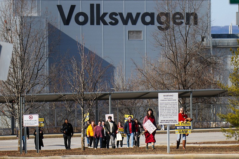 Staff photo by Olivia Ross / A group walks away from the Volkswagen plant with pro-union signs Dec. 18. UAW President Shawn Fain visited the Chattanooga plant amid an organizing campaign.