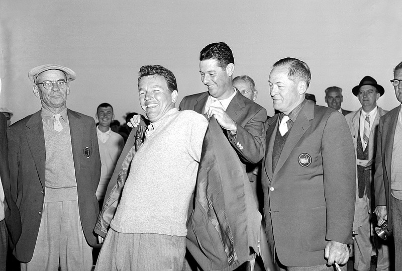 AP photo / Jack Burke Jr. is helped by Cary Middlecoff as he puts on the champion's traditional green jacket after winning the 20th Masters on April 8, 1956, at Augusta National. Burke overcame an eight-shot deficit in the final round, which remains the largest comeback in Masters history. He also won the 1956 PGA Championship.