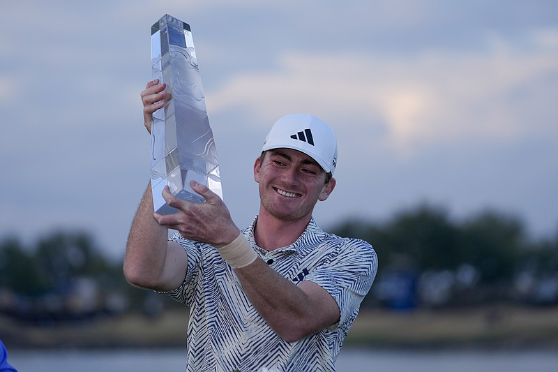 AP photo by Ryan Sun / Nick Dunlap holds his trophy after winning the PGA Tour's American Express tournament Sunday in La Quinta, Calif. Dunlap became the first amateur to win a PGA Tour event since Phil Mickelson at the 1991 Tucson Open.