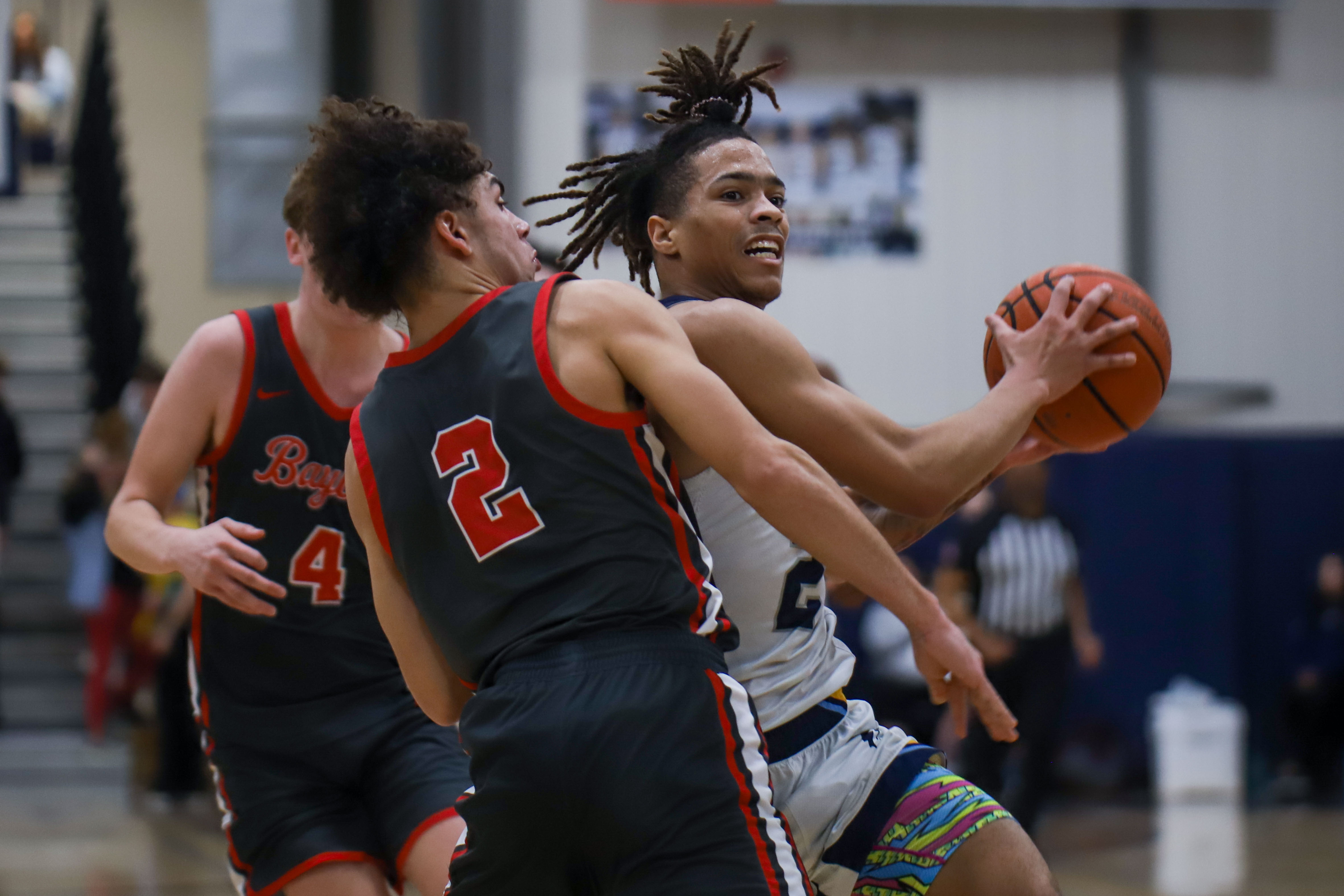 Staff photo by Olivia Ross / CCS's Dre Jackson (2) dribbles by Baylor's Nyziah Whaley (2). Chattanooga Christian School took on Baylor at home on Tuesday, January 23, 2024.