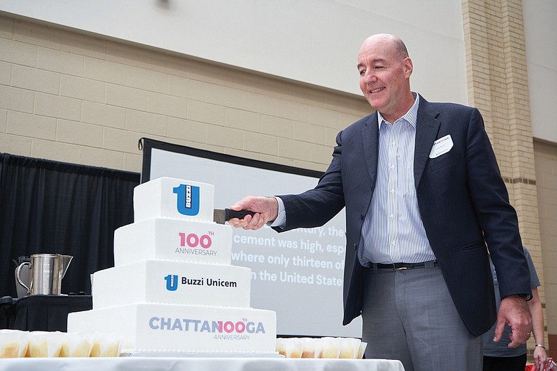 Contributed photo / Luigi Buzzi cuts a cake celebrating his family's 100-year-old business, Buzzi Unicem USA's Signal Mountain Cement Plant.