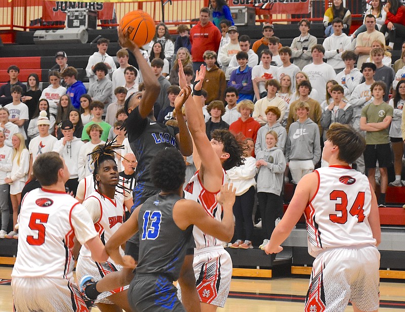 Staff photo by Patrick MacCoon / Red Bank's Anthony Bonner makes his shot through a foul in Monday's District 6-AAA road victory over Signal Mountain. Bonner finished with 28 points as the Lions handed the Eagles their first district loss.