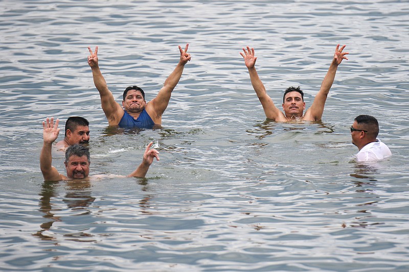 Staff photo by Olivia Ross / A group cheers while swimming July 8 in Chickamauga Lake. Tennessee was 2 to 2.6 degrees warmer in 2023 than the 20th-century average temperature for the state while notching the third-driest year in 70 years, a 2023 climatological summary shows.