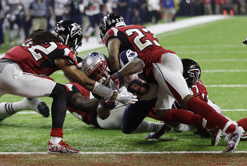 Associated Press file photo / New England Patriots' James White scores the winning touchdown in between Atlanta Falcons' Jalen Collins, left, and Robert Alford during overtime of the NFL Super Bowl LI Feb. 5, 2017, in Houston.