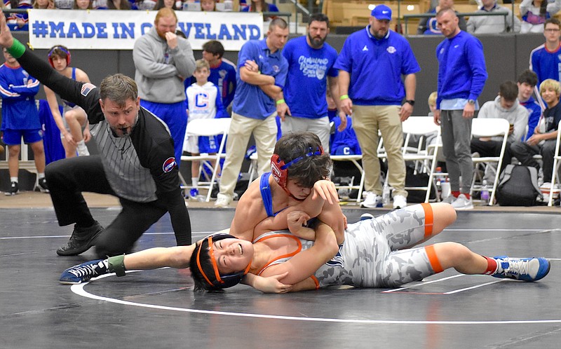 Staff photo by Patrick MacCoon / Cleveland's Jose Cordero, top, wrestles in Saturday's TSSAA Class AA state duals in Franklin.
