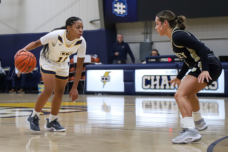 Staff photo by Olivia Ross / Chattanooga Christian's Momo Moore dribbles the ball as she looks to get around visiting Bradley Central's Avery Brewer during a Dec. 5 matchup. Moore is in eighth grade but already a varsity star for the Lady Chargers.