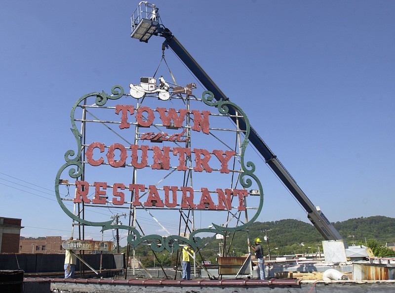 Staff File Photo / Workers with Victory Sign Industries remove the Town and Country Restaurant sign after the closing of the restaurant in 2005. The site at Frazier Avenue and Cherokee Boulevard is now a Walgreens.
