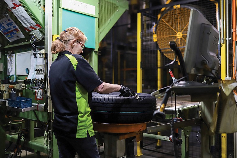 Photo by Olivia Ross / A Nokian Tyres employee inspects a finished tire at the company's plant in Dayton, Tennessee.