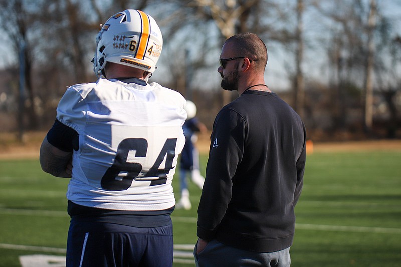 Staff photo by Olivia Ross / Gerry Pacitti, right, who oversees the strength and conditioning program for the UTC football team, watches as the Mocs go through a spring practice session Wednesday.