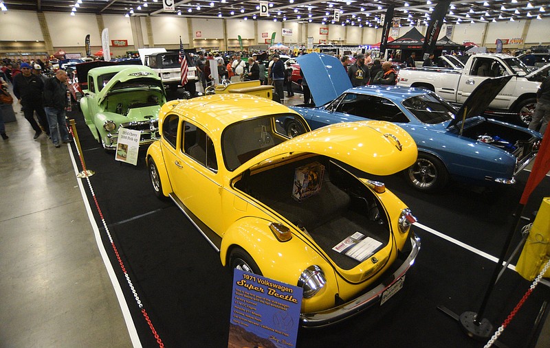 Staff photo by Matt Hamilton / Visitors look at a 1971 Volkswagen Super Beetle and other cars during the 56th Annual World of Wheels Custom Auto Show at the Chattanooga Convention Center on Jan. 6. VW celebrates its 75 years in America in a new commercial to air during Sunday's Super Bowl.