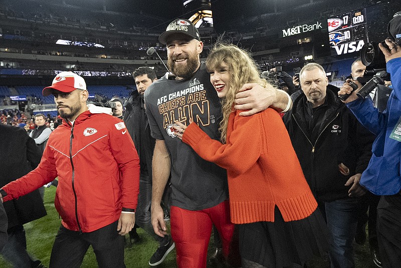 FILE - Kansas City Chiefs tight end Travis Kelce and Taylor Swift walk together after an AFC Championship NFL football game between the Chiefs and the Baltimore Ravens, Jan. 28, 2024, in Baltimore. For weeks, scrutiny over Swift's travel has been bubbling up on social media, with people pointing out the planet-warming emissions of carbon dioxide released with every flight. (AP Photo/Julio Cortez, File)