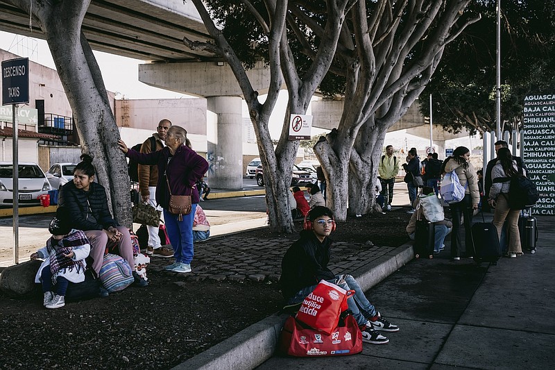 Photo/Mark Abramson/The New York Times / A crossing in San Ysidro, Calif., which was temporarily closed, has now been reopened. Migrants wait there on Jan. 4, 2024. Local officials on the border say they are the ones being overwhelmed by the thousands of migrants arriving at their doors.