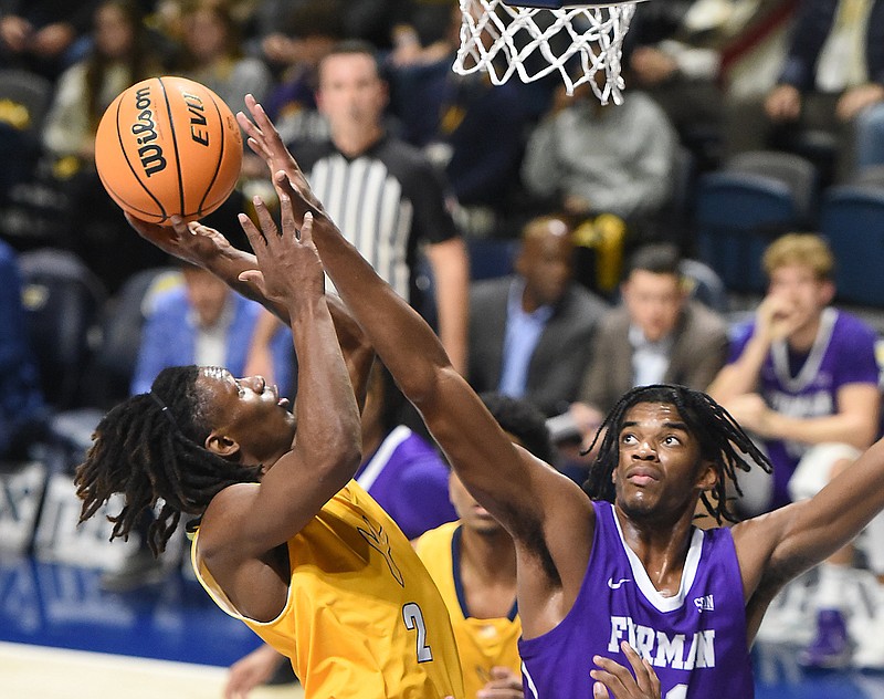 Staff file photo by Matt Hamilton / UTC's Trey Bonham, left, racked up 31 points, seven assists and four steals during an 89-61 win at UNC Greensboro on Saturday.