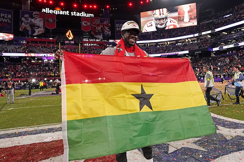 Kansas City Chiefs cornerback Ekow Boye-Doe poses with flag of Ghana after defeating the San Francisco 49ers in overtime of the NFL Super Bowl 58 football game Sunday in Las Vegas. The 24-year-old is a native of Accra, Ghana, which has been announced as a new sister city to Chattanooga. (AP Photo/Steve Luciano)