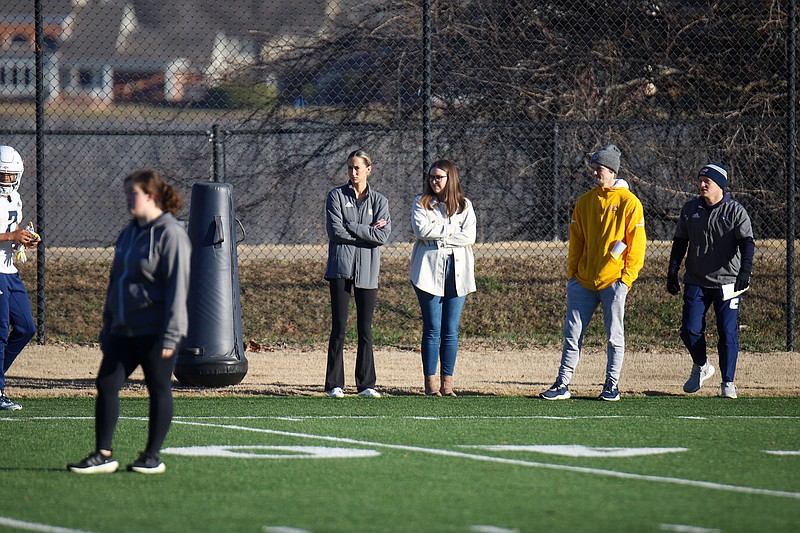 Staff photo by Olivia Ross / Hannah Braxton, Recruiting Coordinator, and Emily Baustert, Director of Football Operations, watch during UT Chattanooga football practice on Wednesday, February 7, 2024. �