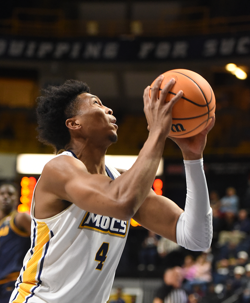 Staff photo by Matt Hamilton/ UTC (4) Sam Alexis drives to the hoop for a slam dunk during their game against ETSU at McKenzie Arena on Wednesday, February 14, 2024.