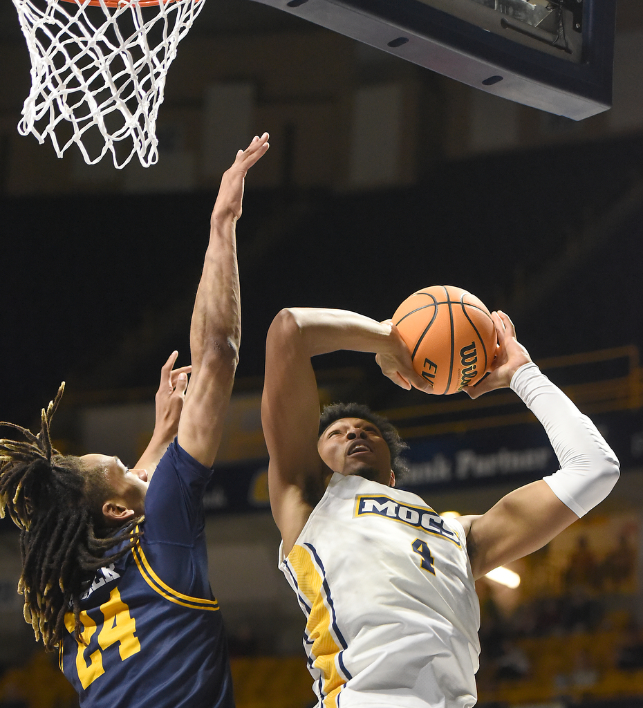 Staff photo by Matt Hamilton/ ETSU (24) Jadyn Parker defends as UTC (4) Sam Alexis puts up a shot during their game at McKenzie Arena on Wednesday, February 14, 2024.