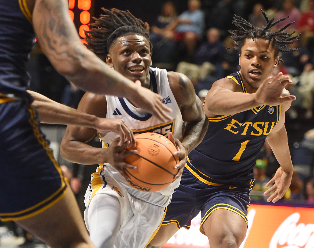 Staff photo by Matt Hamilton/ ETSU (1) Quimari Peterson defends as UTC (2) Trey Bonham drives the lane during their game at McKenzie Arena on Wednesday, February 14, 2024.