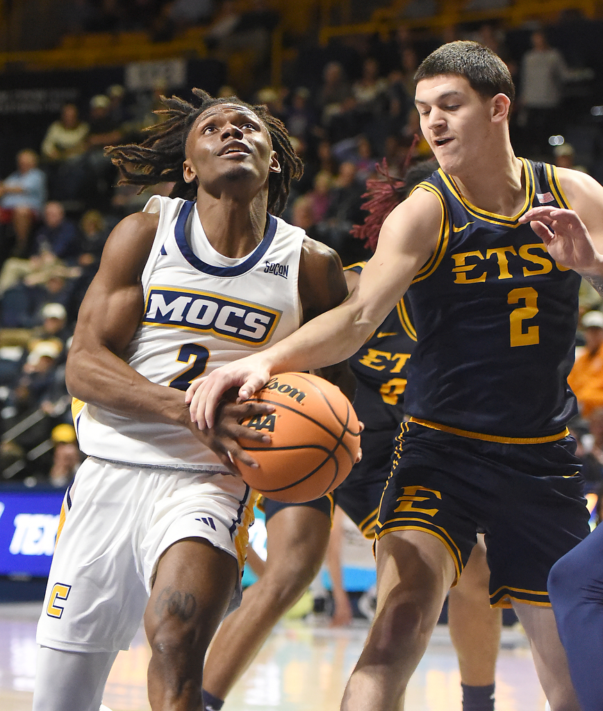 Staff photo by Matt Hamilton/ ETSU (2) Maki Johnson fouls UTC (2) Trey Bonham as he drives the lane during their game at McKenzie Arena on Wednesday, February 14, 2024.
