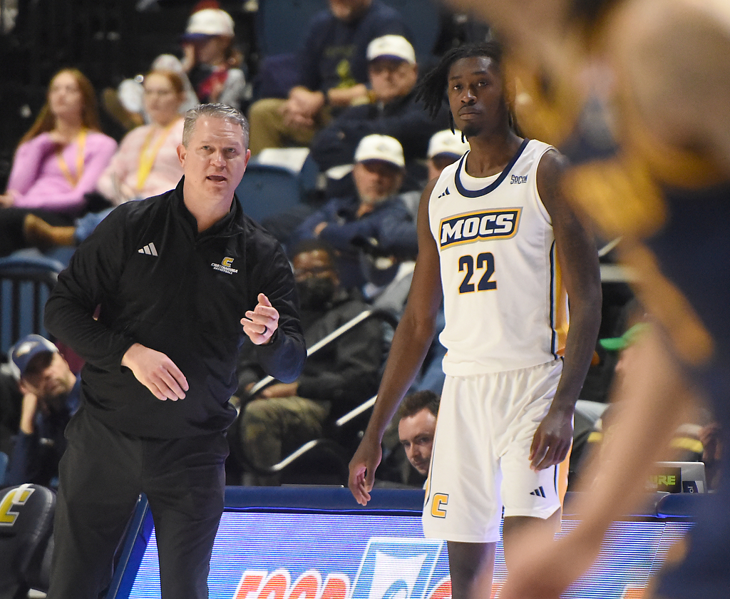 Staff photo by Matt Hamilton/ Coach Dan Earl talks to UTC (22) Demetrius Davis before he goes into the game against ETSU during their game at McKenzie Arena on Wednesday, February 14, 2024.