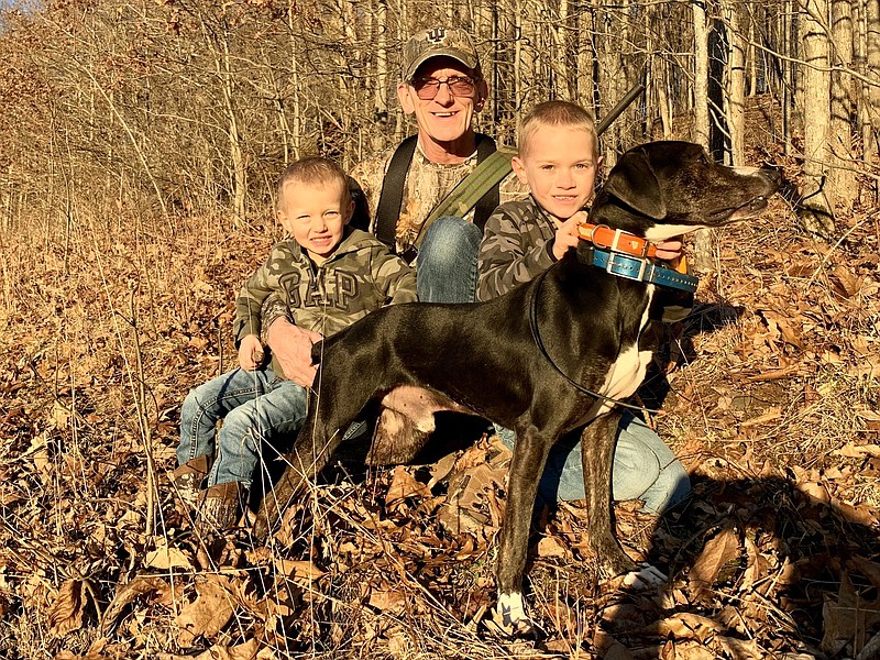 Contributed photo / Chuck Loudin poses with his grandsons and their mountain cur dog Crazy Horse. Almost all hunters share a common memory from their younger days of a simple hunt with family, writes "Guns & Cornbread" columnist Larry Case.