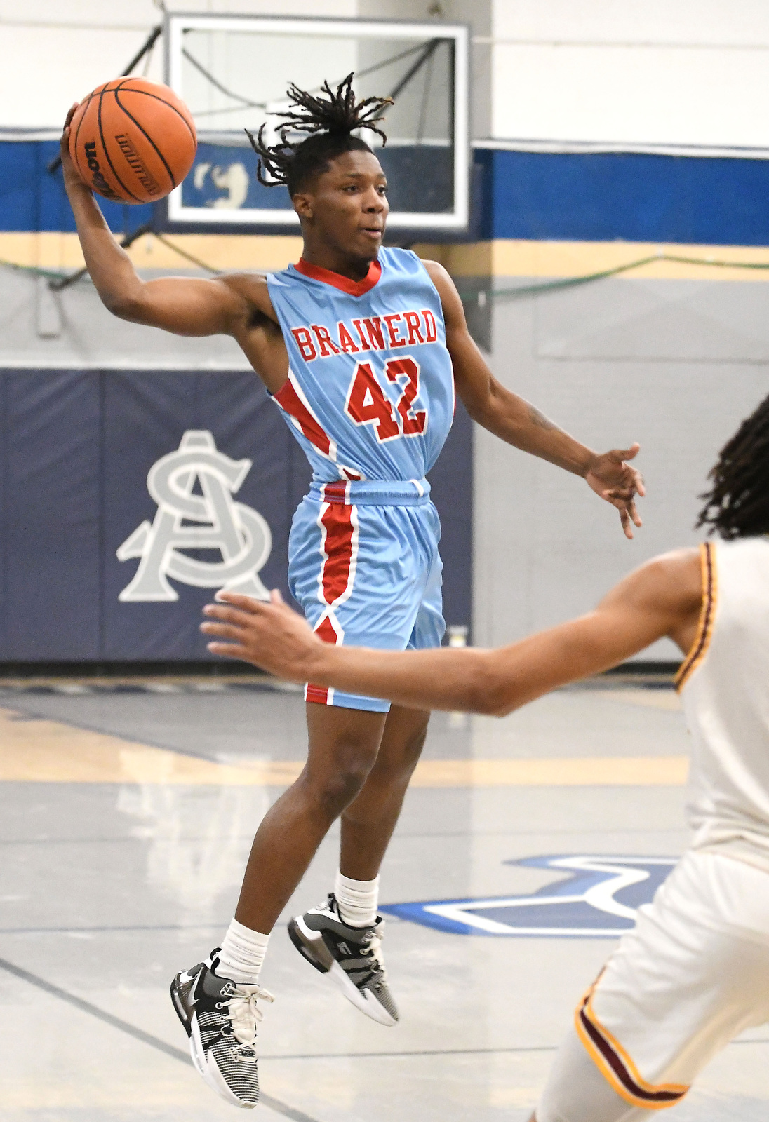 Staff Photo by Robin Rudd / Brainerd's Kendrick Jones (42) leaps to pass. The Brainerd Panthers met the Tyner Rams in the District 4-AA tournament championship, played at Chattanooga School for Arts and Sciences, on February 20, 2024.
