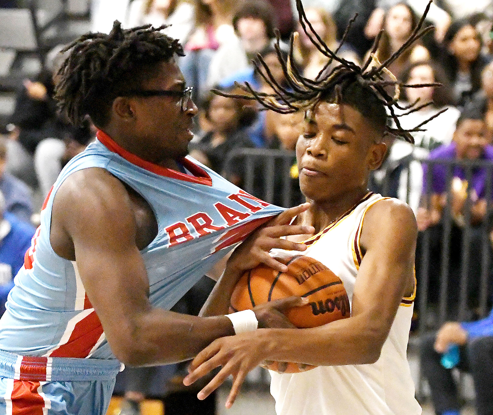 Staff Photo by Robin Rudd / Brainerd's Jordan Smith (20) and Tyner's Adarius Brewster (10) struggle for the ball. The Brainerd Panthers met the Tyner Rams in the District 4-AA tournament championship, played at Chattanooga School for Arts and Sciences, on February 20, 2024.