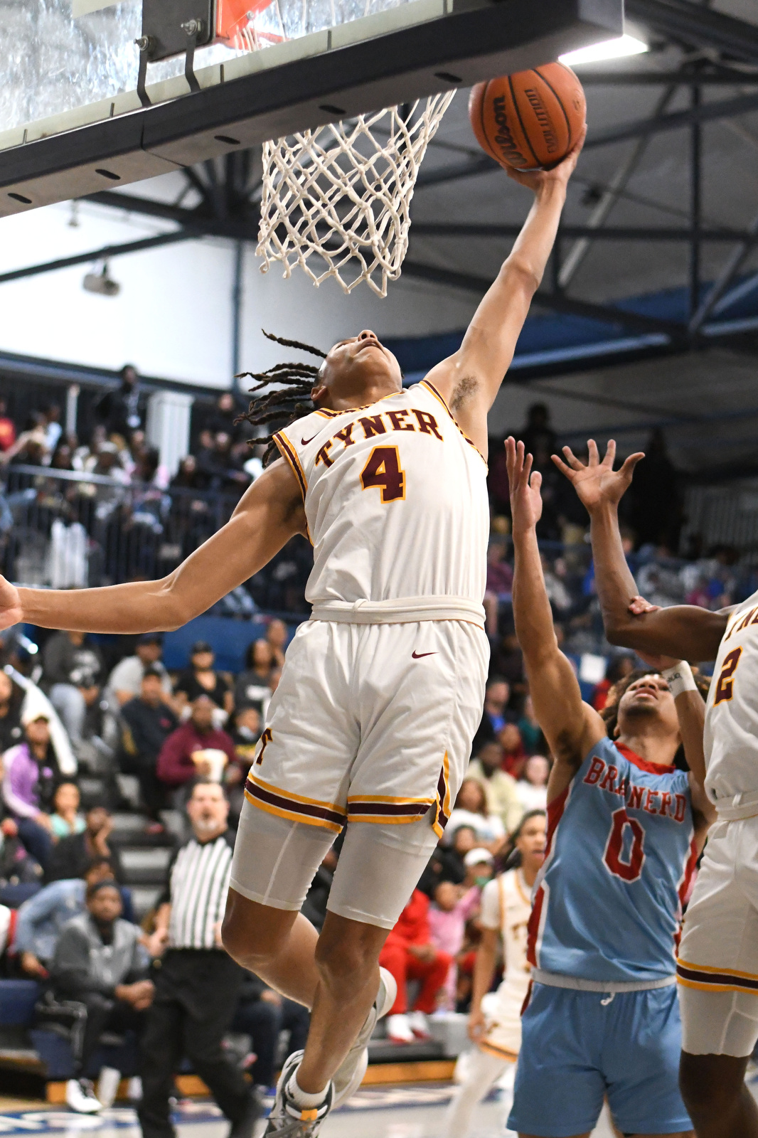 Staff Photo by Robin Rudd / Tyner's Zion Pinkerston pulls down an offensive rebound. The Brainerd Panthers met the Tyner Rams in the District 4-AA tournament championship, played at Chattanooga School for Arts and Sciences, on February 20, 2024.