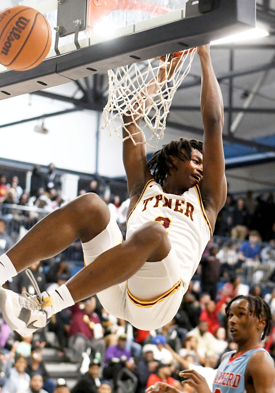 Staff Photo by Robin Rudd / As the ball bounces up after his dunk, Tyner's Rodney Henderson smiles and looks back toward the Ram bench. Tyner started strong and never looked back in claiming the District 4-AA championship over Brainerd at Arts & Sciences Tuesday.