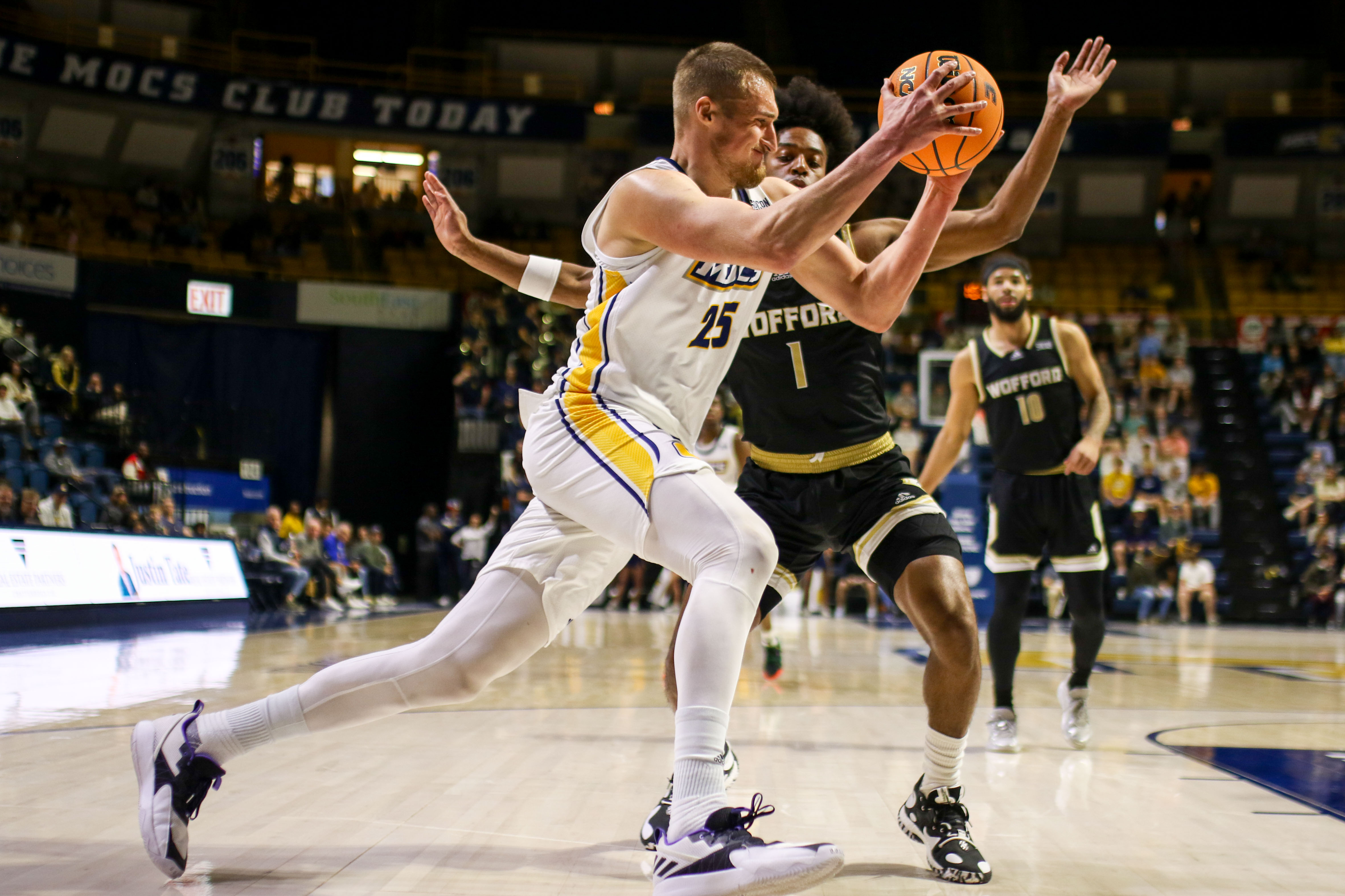 Staff photo by Olivia Ross / UTC's Jan Zidek (25) drives past Wofford's Chase Cormier during a SoCon game Wednesday night at McKenzie Arena.