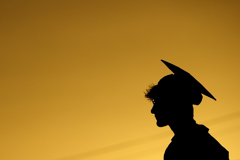 File Photo/Chattanooga Times Free Press Via AP / Coleton McLemore is silhouetted against the sky during commencement exercises for the Class of 2020 at Lakeview-Fort Oglethorpe High School on July 31, 2020.