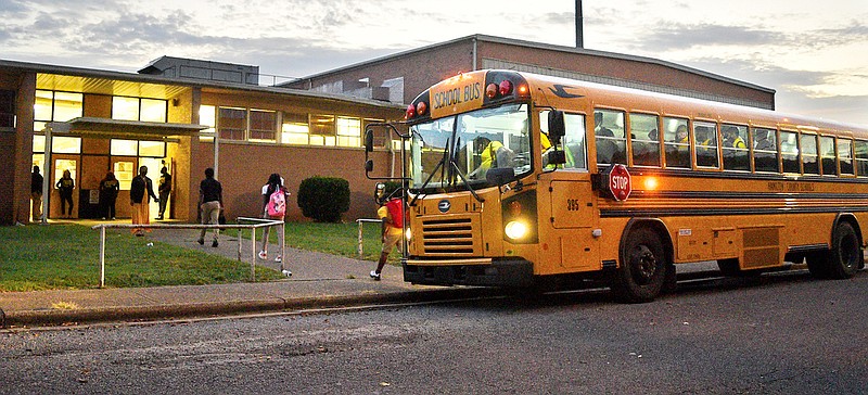 Staff File Photo By Robin Rudd / Students arrive by bus, before dawn, at Orchard Knob Middle School early in the 2021-2022 school year.