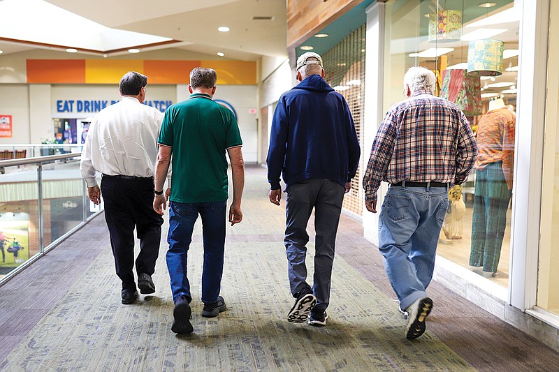 Staff photo by Olivia Ross / From left, Stephen Pike, David Hawkins, Jerry Ownbey and Mike Hunter walk the Hamilton Place mall.