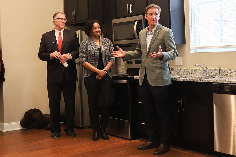 Staff photo by Olivia Ross / Mayor Tim Kelly, right, speaks Friday at the grand opening of Mai Bell II, an affordable housing complex in Highland Park. Next to him stands Jerry Lee with Builtwell Bank, far left, and Andrea Hardaway, board chair.