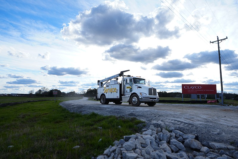 A truck leaves the site of a planned Rivian electric truck plant Thursday, March 7, 2024, in Rutledge,Ga. Rivian says it's pausing construction of the $5 billion manufacturing plant in Georgia. (AP Photo/John Bazemore)
