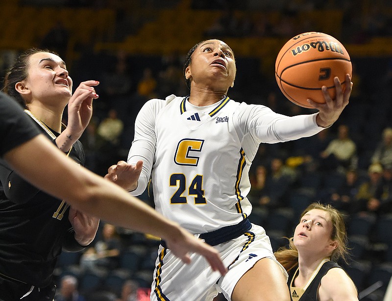 Staff photo by Matt Hamilton/ Wofford (11) Vitoria Tuilave  defends as UTC (24) Jada Guinn drives through the paint during their game at McKenzie Arena on Thursday, February 1, 2024.