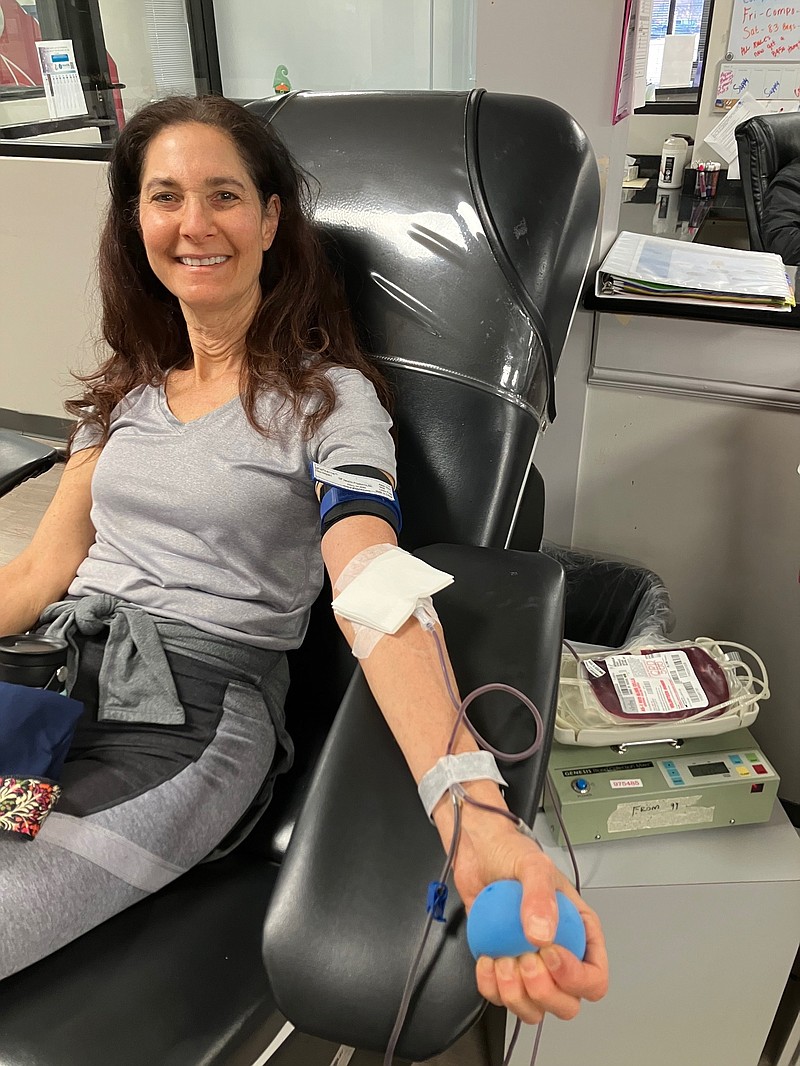 Contributed Photo / With the promise of receiving peanut butter crackers for her effort, Dana Shavin donates blood. The process requires little more than 15 sedentary minutes, except for clenching and unclenching your fist.