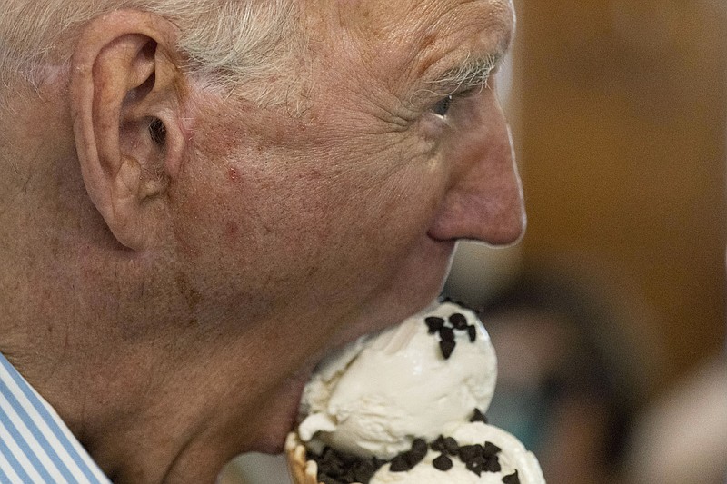 File photo/Alex Brandon/ The Associated Press / President Joe Biden takes a bite of ice cream at Moomers Homemade Ice Cream, on Saturday, July 3, 2021, in Traverse City, Michigan.