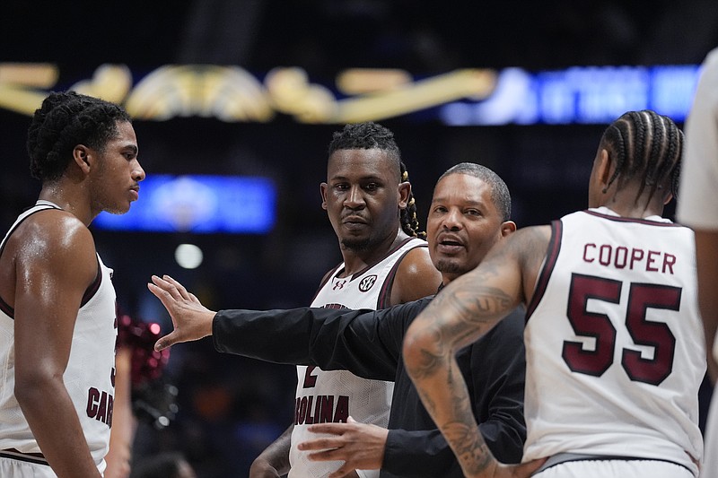 AP photo by John Bazemore / South Carolina men's basketball coach Lamont Paris speaks with his players during a timeout as the Gamecocks take on Arkansas during the second round of the SEC tournament Thursday night in Nashville.