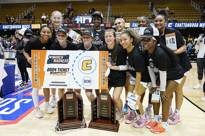 AP photo by Kathy Kmonicek / The UTC women's basketball team poses with its SoCon championship trophies and a ceremonial NCAA tournament ticket after beating UNC Greensboro to win the league tournament on March 10 in Asheville, N.C.