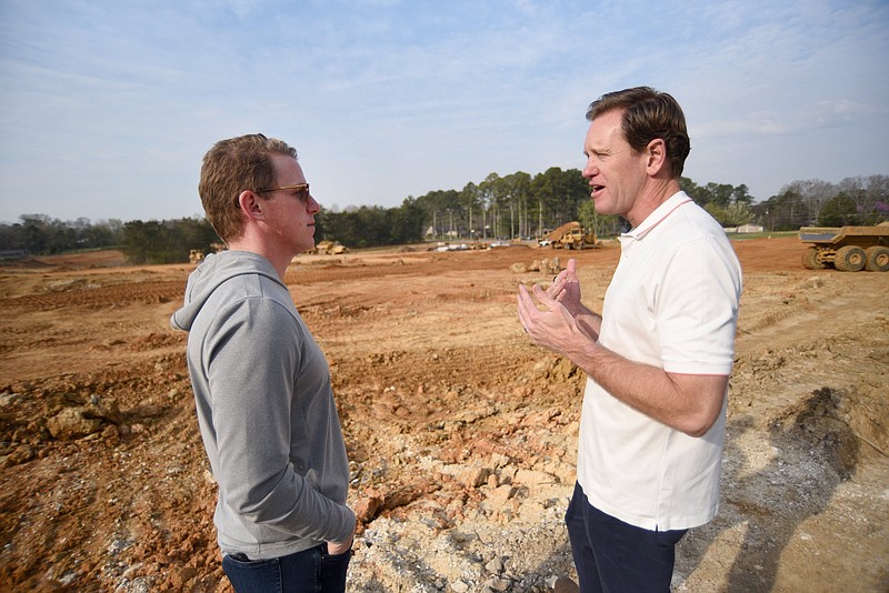 Staff photo by Matt Hamilton / Marcus Lyons, left, talks to Eric Fuller on March 22 at a new housing development in Ooltewah. The pair are business partners in LFG Homes.