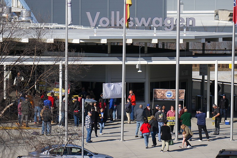 Staff photo by Olivia Ross / A group gathers outside of Volkswagen Chattanooga with signs in December. UAW President Shawn Fain visited outside the plant with union supporters and community and faith leaders.