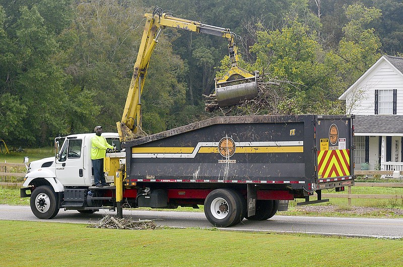 Staff Photo by Robin Rudd / A Chattanooga Public Works employee operates a brush truck to remove debris on Davidson Road in East Brainerd in 2021. Starting April 1, Chattanooga residents can use 311 to request bulk trash pickup.