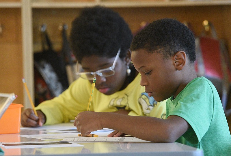 Staff photo by Matt Hamilton / Kobi Higgins, right, and Cyanna Bryant, both 10, work on a reading worksheet at Battle Academy on June 7, 2022. Under Tennessee's 2021 literacy law, tough new retention policies began affecting last year's third graders and this year's fourth graders.