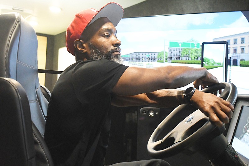 Staff Photo by Robin Rudd / Student Thomas Spencer makes a right-hand turn Aug. 14 on the driving simulator at the Chattanooga State Community College commercial truck school on Adams Road in Hixson. WorkHound regularly surveys truck drivers to get their feedback about their jobs.