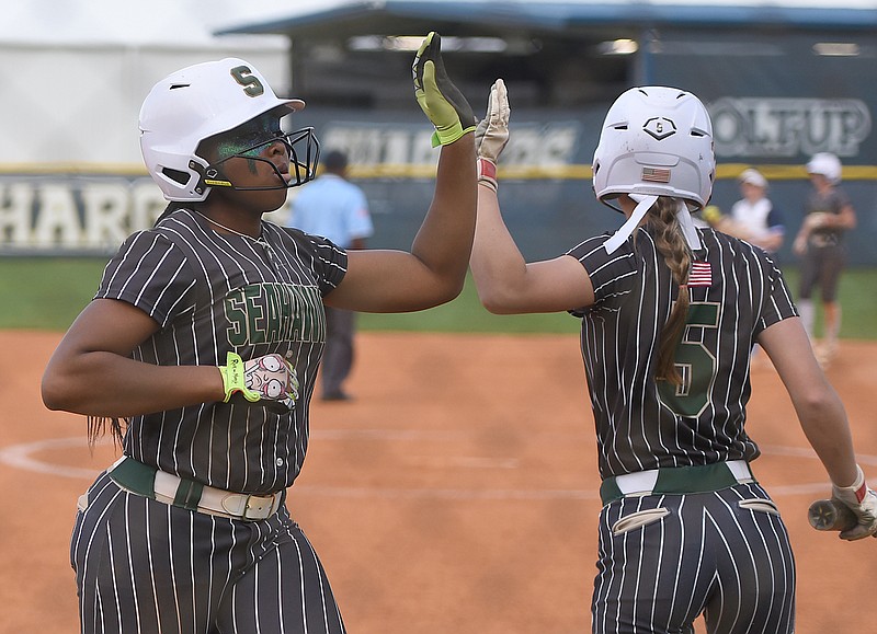 Staff photo by Matt Hamilton / Silverdale Baptist Academy's Jaliyah Whitaker, left, celebrates with Kennedy Stinson after scoring during Thursday's softball game at Chattanooga Christian School.